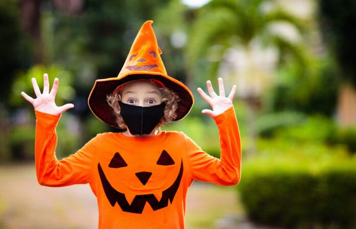 Kids trick or treat. Halloween in face mask.