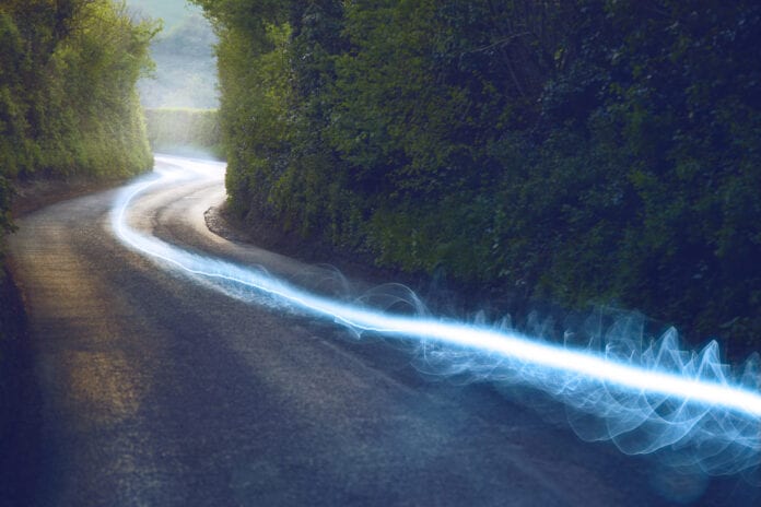 A blue fiber optic cable running down the countryside
