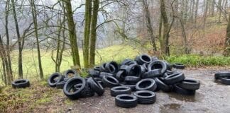 Fly-tipping prosecution warning after tyres dumped on rural road