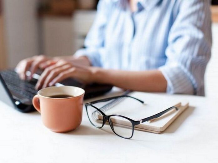 7_Remote-working-from-home-Freelancer-workplace-in-kitchen-with-laptop-cup-of-coffee