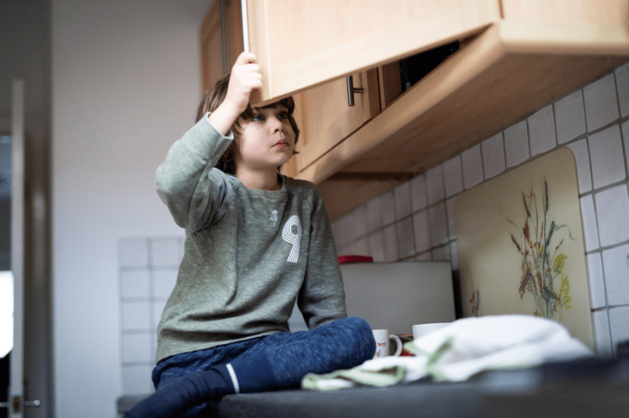 young_boy_looking_in_cupboard-2