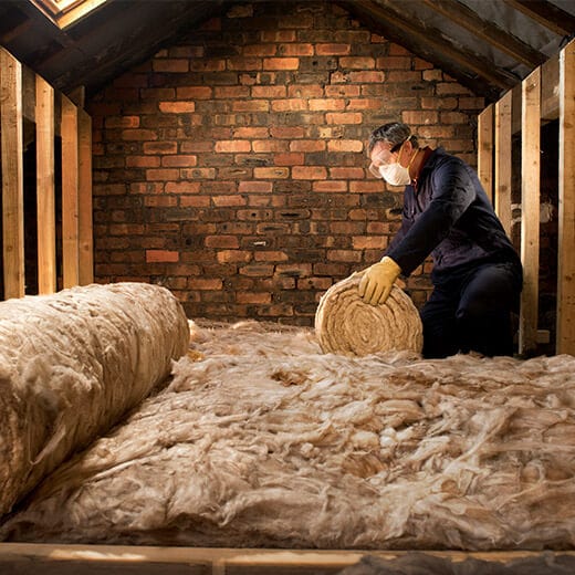 man-laying-loft-insulation-min